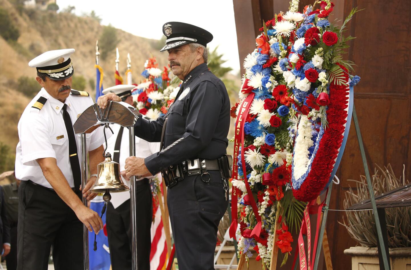 Los Angeles Fire Chief Ralph Terrazas, left, and LAPD Chief Charlie Beck, right, perform the ringing of the bell ceremony for fallen firefighters during the 9/11 Remembrance Ceremony.