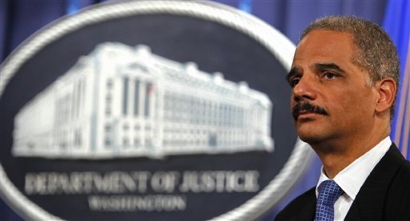 In this Feb. 25, 2009, file photo, Attorney General Eric Holder listens during a news conference at the Justice Department in Washington. (AP Photo/Lawrence Jackson, File)