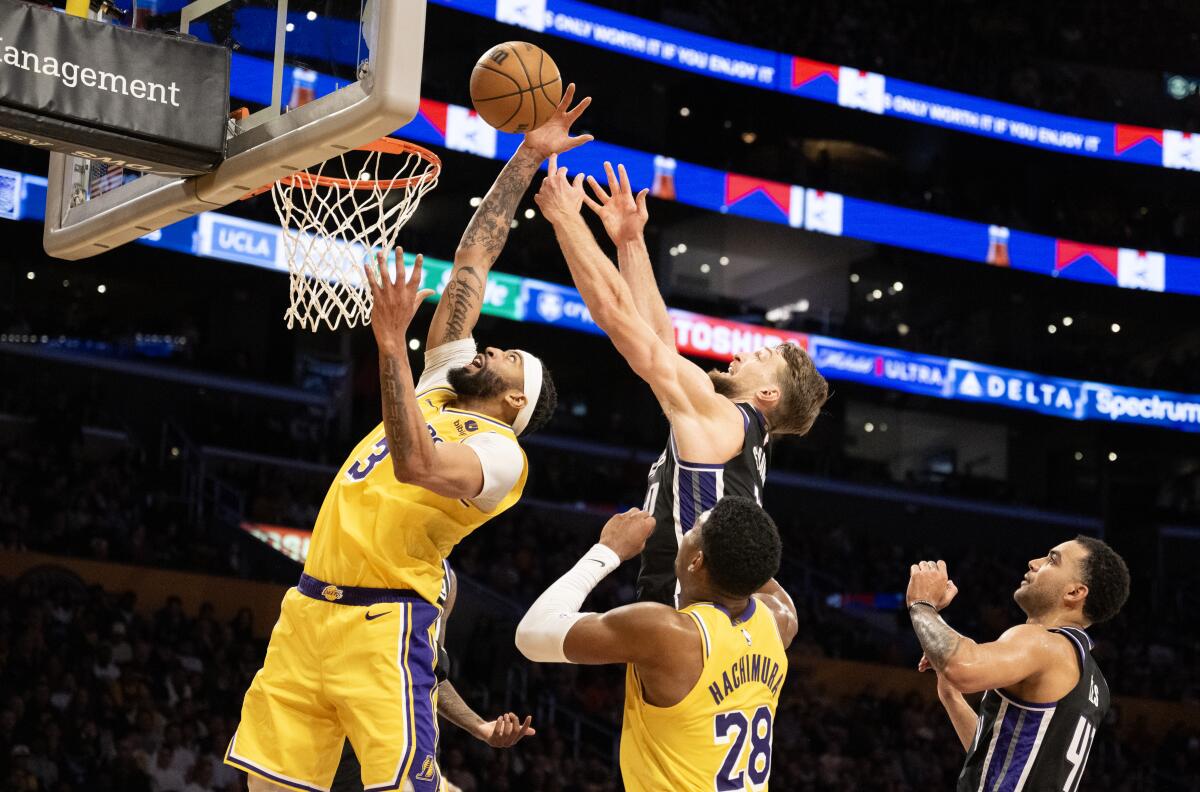 LOS ANGELES, CA - MARCH 6, 2024: Los Angeles Lakers forward Anthony Davis (3) battles Sacramento Kings forward Domantas Sabonis (10) for a rebound in the fourth quarter on March 6, 2024 at Crypto.com Arena in Los Angeles, California.(Gina Ferazzi / Los Angeles Times)