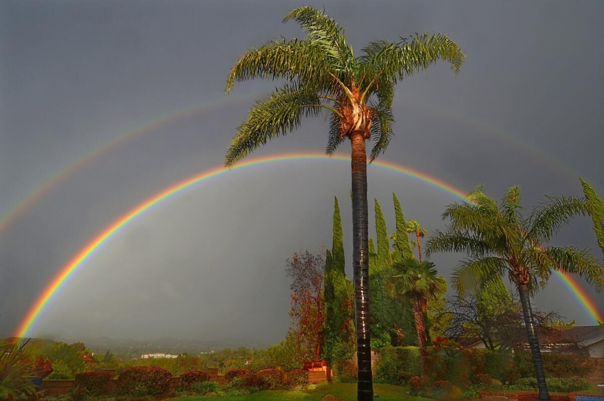 In a brief flash of sunlight between rainfalls, a double rainbow appears over Thousand Oaks.