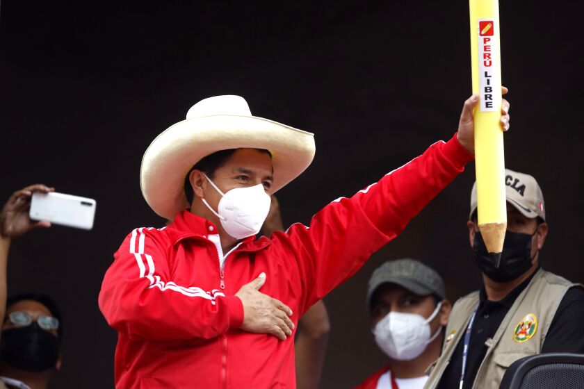 Free Peru party presidential candidate Pedro Castillo holds up a large, mock pencil during his closing campaign rally in Lima, Peru, Thursday, June 3, 2021. The former rural school teacher will face rival candidate Keiko Fujimori in a June 6 election. (AP Photo/Guadalupe Pardo)