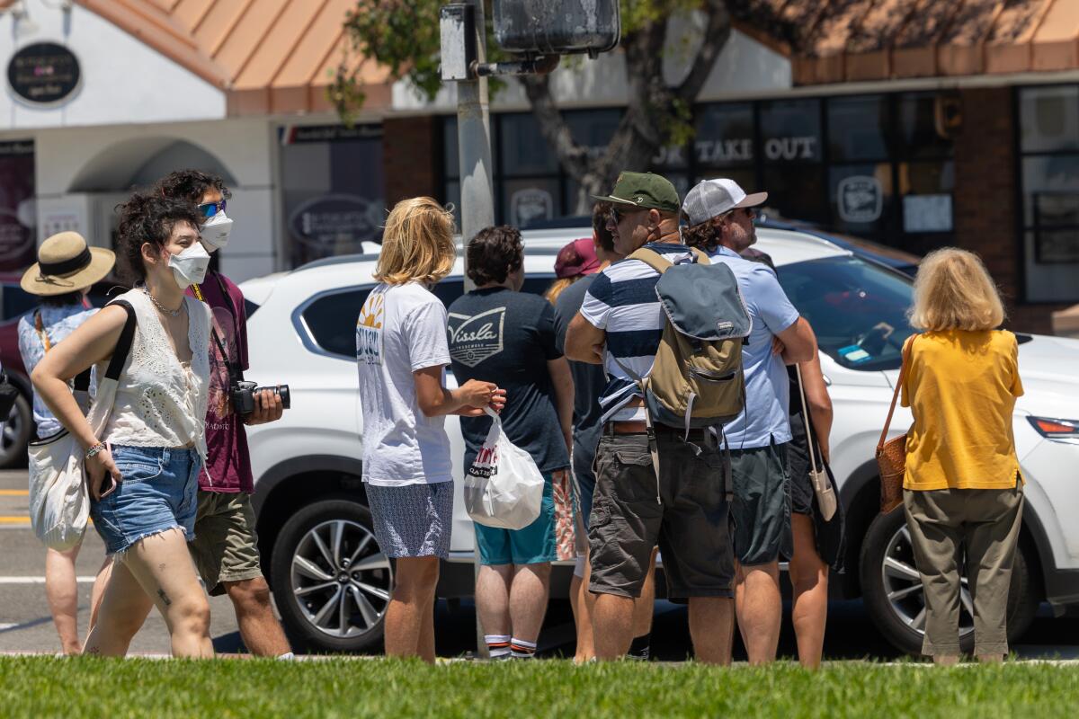 Those out and about in Laguna Beach on Sunday included some in masks as COVID continued to spread.