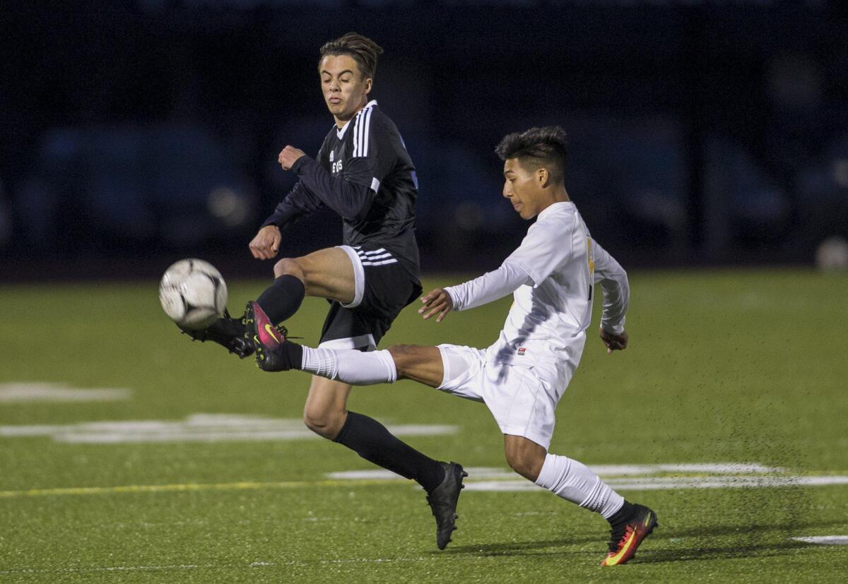 Corona del Mar’s Niko Urban battles for a ball against Godinez’s Oscar Salas in the quarterfinals of the CIF Southern Section Division 2 playoff game on Saturday.