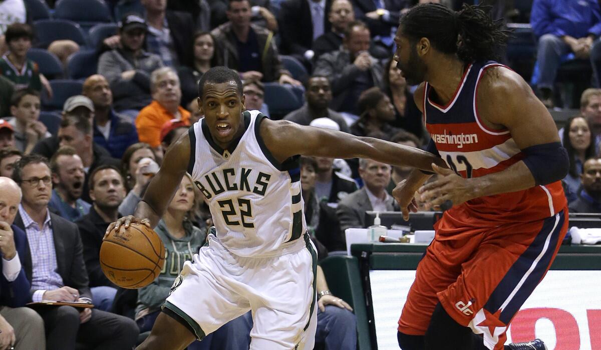 Bucks guard Khris Middleton drives against Wizards center Nene during a game last season.