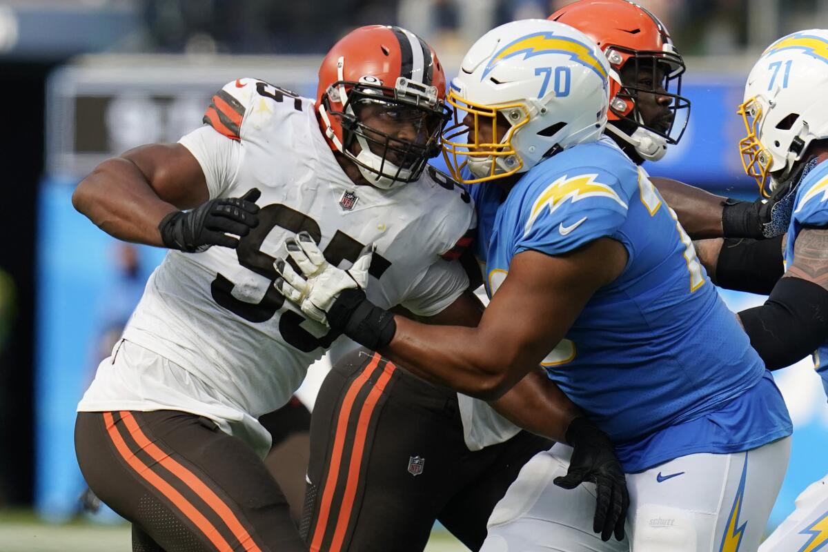 Chargers offensive tackle Rashawn Slater, right, blocks Cleveland Browns defensive end Myles Garrett during the second half.