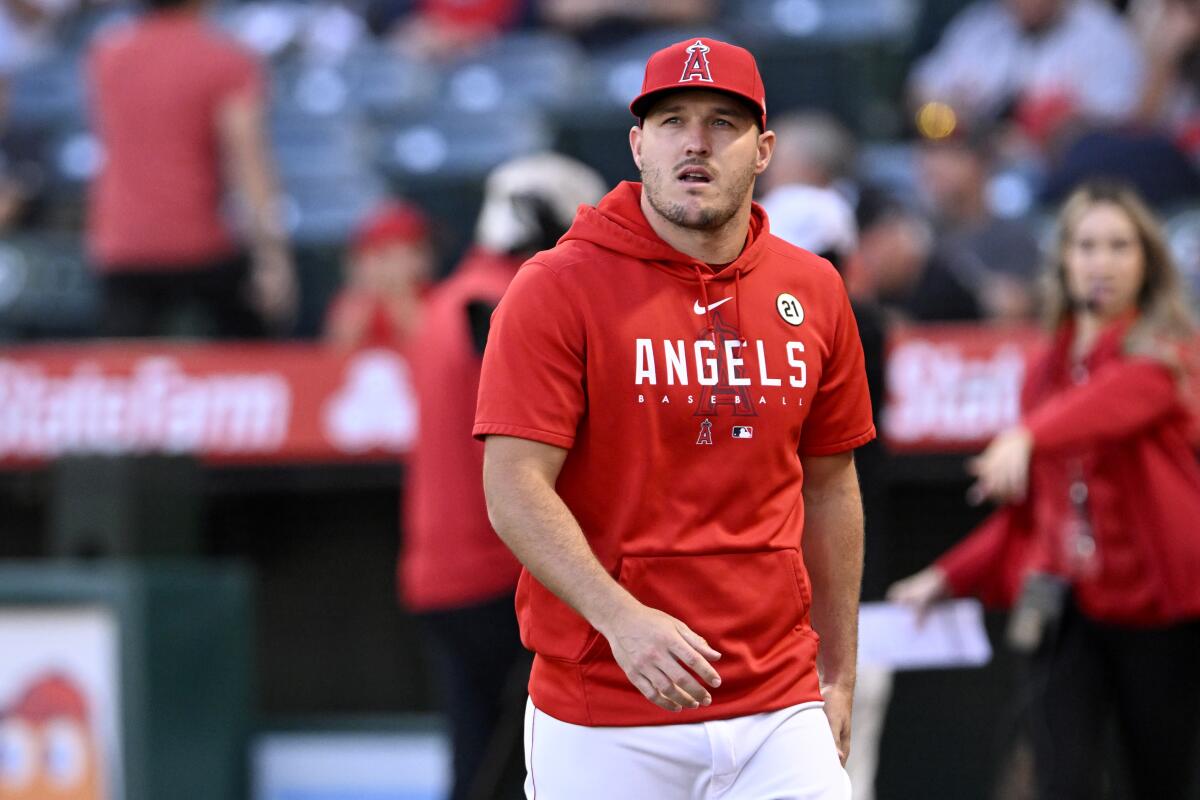 Angels' Mike Trout walks back to the dugout after receiving the MLB Robert Clemente Award.