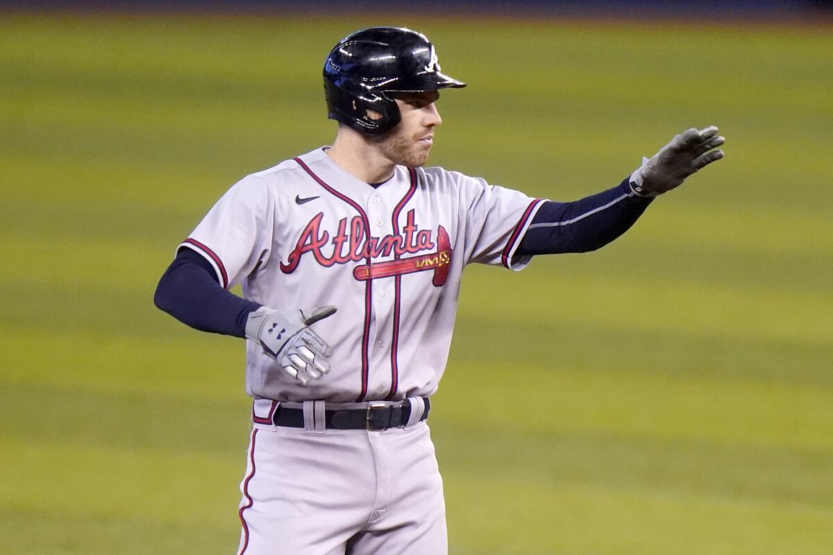 The Atlanta Braves' Freddie Freeman reacts after hitting a double against the Miami Marlins.