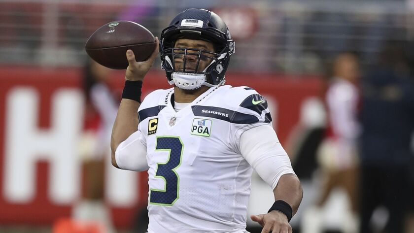 Russell Wilson of the Seattle Seahawks passes the ball against the San Francisco 49ers.