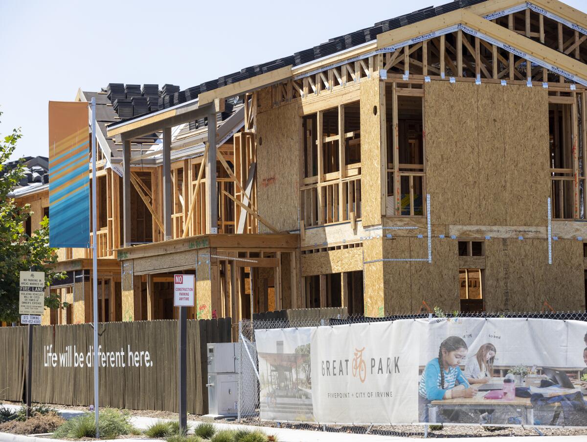 Workers construct a new home in the Great Park Neighborhoods in Irvine in 2021.
