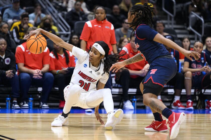 Louisville guard Morgan Jones (24) attempts to maintain control of the basketball as she falls backward during the second quarter of the team's Sweet 16 college basketball game against Mississippi in the women's NCAA Tournament in Seattle, Friday, March 24, 2023. (AP Photo/Caean Couto)