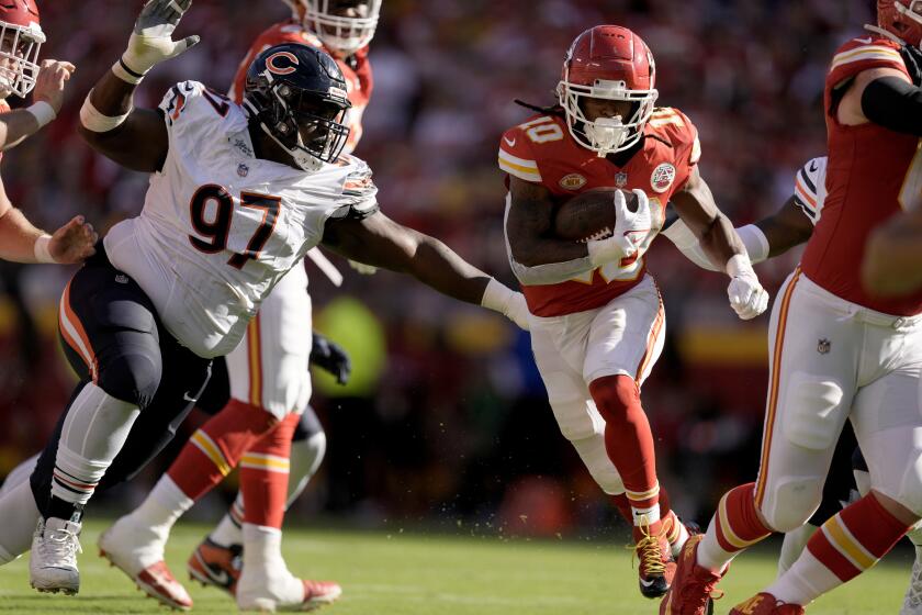 Kansas City Chiefs running back Isiah Pacheco (10) runs with the ball as Chicago Bears defensive tackle Andrew Billings (97) defends during the first half of an NFL football game Sunday, Sept. 24, 2023, in Kansas City, Mo. (AP Photo/Charlie Riedel)