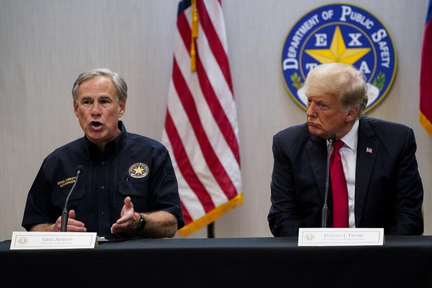 Texas Gov. Greg Abbott, left, and former President Donald Trump attend a security briefing with state officials and law enforcement at the Weslaco Texas Department of Public Safety (DPS) headquarters before touring the U.S.-Mexico border wall on Wednesday, June 30, 2021, in Weslaco, Texas. (Jabin Botsford/The Washington Post via AP, Pool)