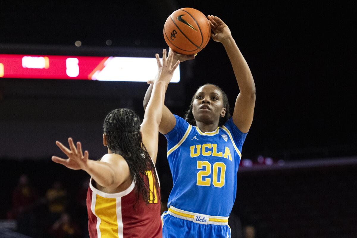 UCLA guard Charisma Osborne shoots over USC guard Destiny Littleton during a game.