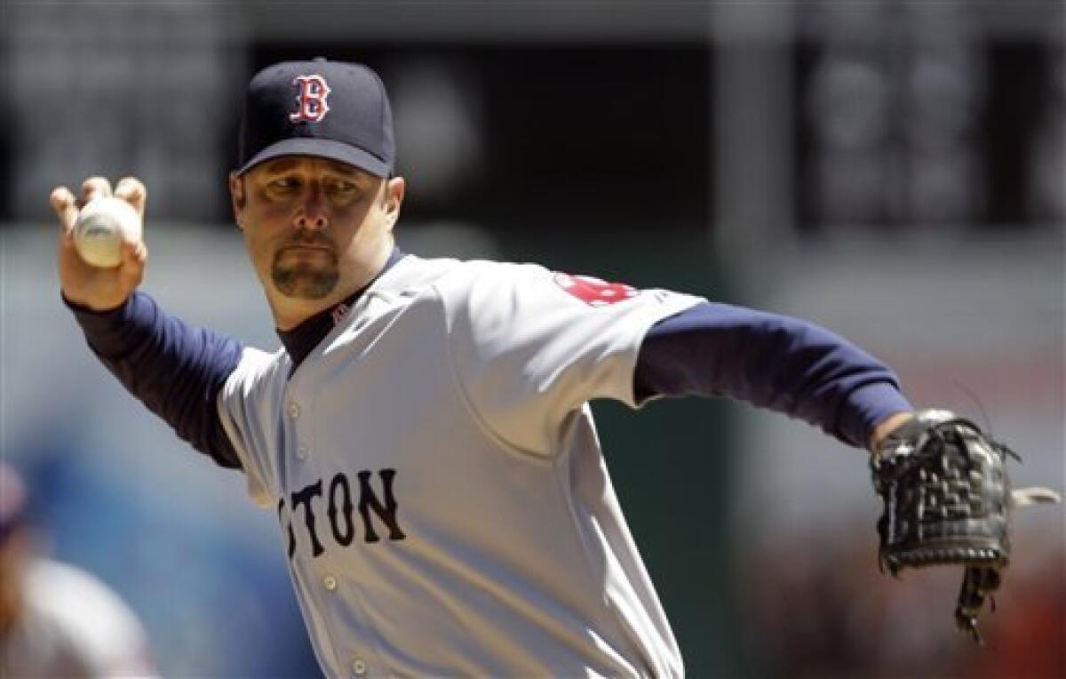 Boston Red Sox third baseman Mike Lowell makes the throw on a