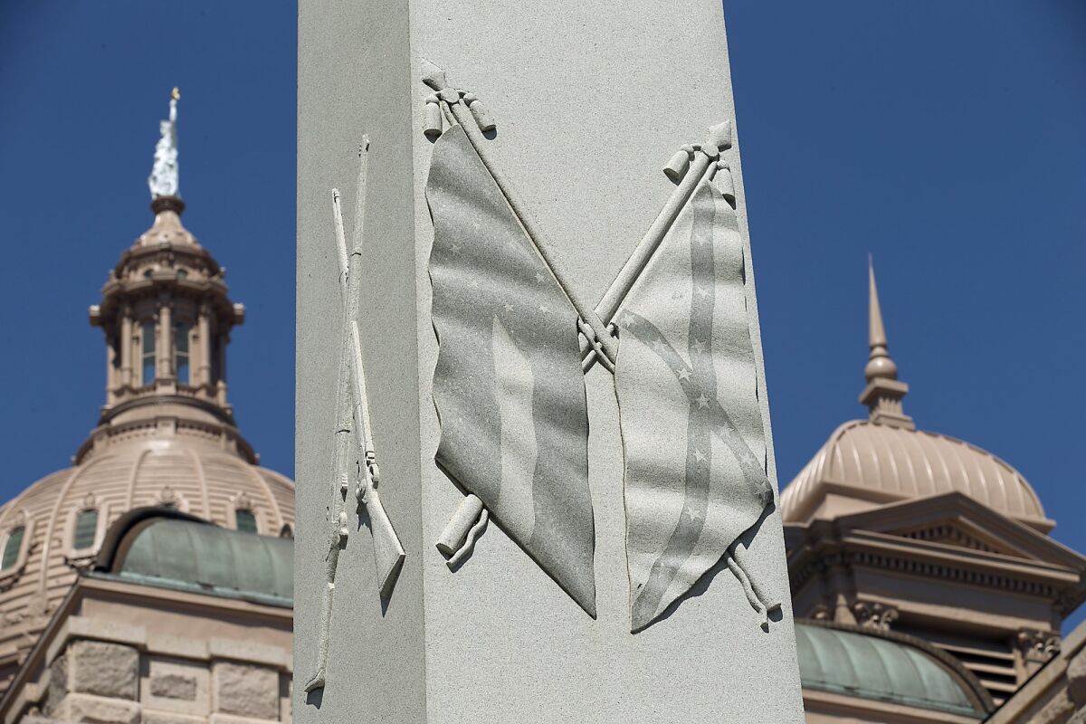 A Civil War memorial on the east grounds of the state Capitol in Austin, Texas, depicts Confederate flags. New school textbooks in the state are being criticized for minimizing the roles of slavery in the Civil War and segregation in the Jim Crow-era South.