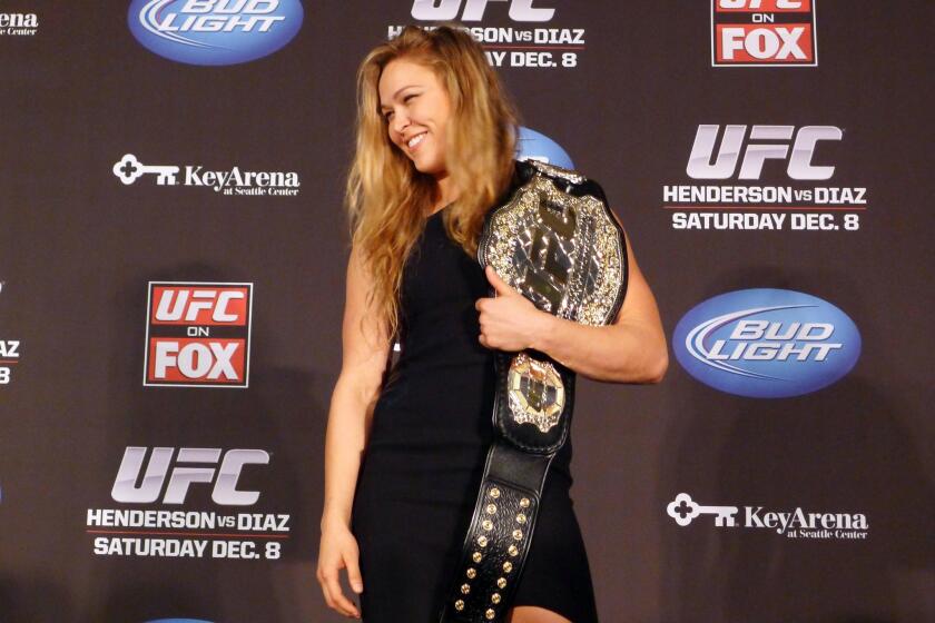 Ronda Rousey, shown in December with her UFC bantamweight championship belt, says she's "preparing for people to get the worst idea of who I am" when she appears on "The Ultimate Fighter."