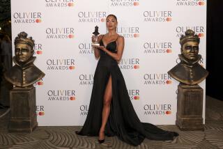 Nicole Scherzinger of "Sunset Boulevard" poses with her trophy in the winner's room during the Olivier Awards 
