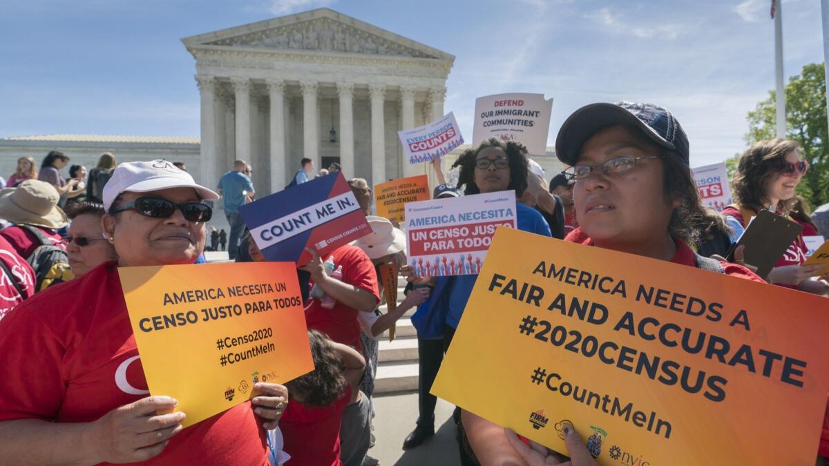 Immigration activists rally outside the Supreme Court as the justices hear arguments over the Trump administration's plan to ask about citizenship on the 2020 census.