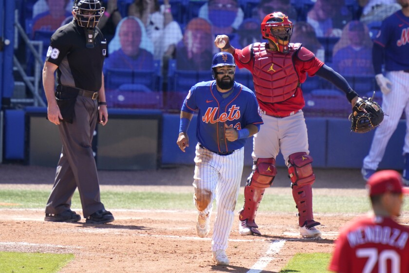 New York Mets' Luis Guillorme, center, draws a walk off St. Louis Cardinals relief pitcher Jordan Hicks during the fifth inning of a spring training baseball game, Sunday, March 14, 2021, in Port St. Lucie, Fla. (AP Photo/Lynne Sladky)