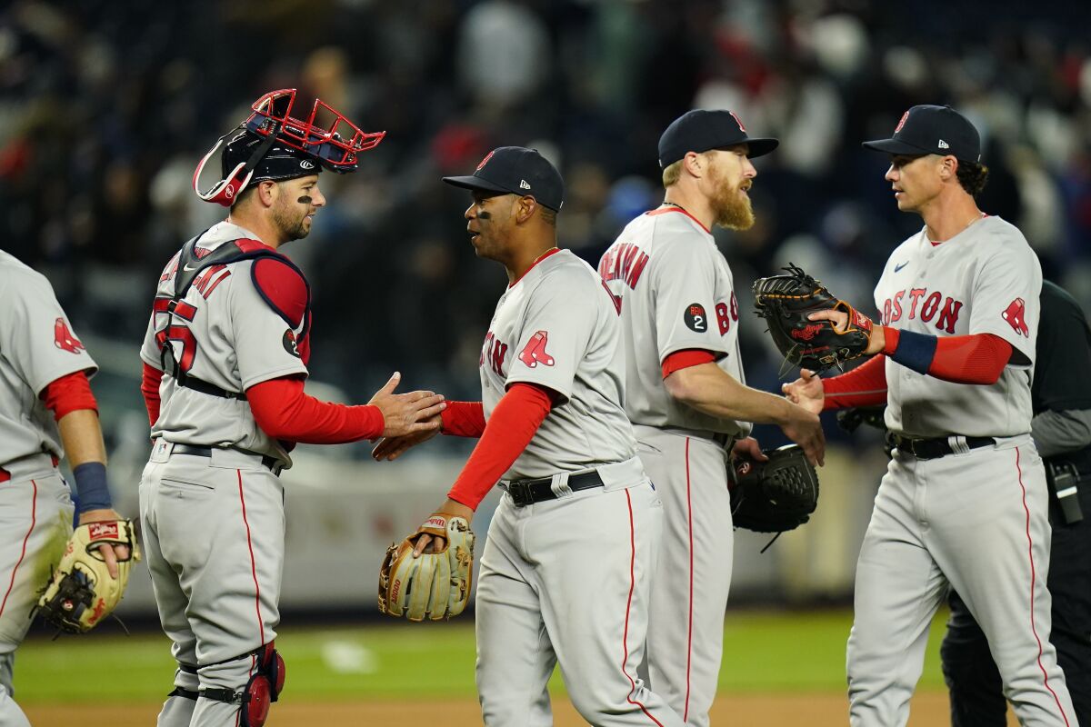 Boston Red Sox's Bobby Dalbec, right, and relief pitcher Jake Diekman, second from right celebrates with teammates after a baseball game against the New York Yankees Sunday, April 10, 2022, in New York. The Red Sox won 4-3. (AP Photo/Frank Franklin II)