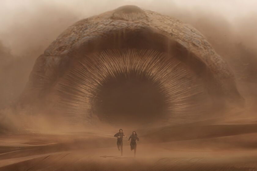 **DO NOT USE. FOR ENVELOPE ONE SHOT FEATURE 11/23/2021: Denis Villeneuve's epic journey "Dune" is rife with interstellar war and slithering monsters. This scene pins the lives of Paul Atreides (Timothee Chalamet) and his mother, Lady Jessica (Rebecca Ferguson), against a gigantic, sound-hunting sandworm as they run for shelter. For this sequence, cinematographer Greig Fraser captured the scale and growling undercurrent of the untouched sand dunes of Jordan using IMAX and later finessed by visual effects