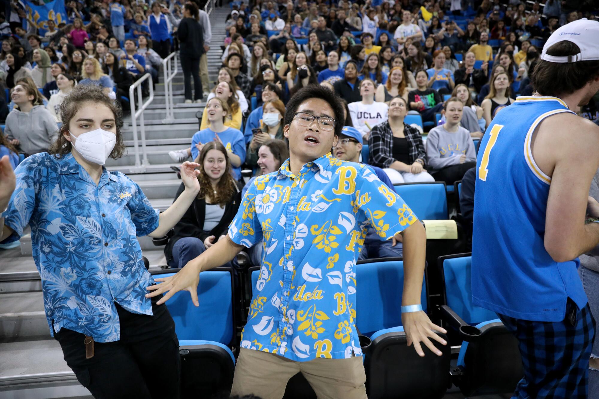 UCLA gymnastics super fan Josh Lim and friend Laura DeFalco dance during a meet.