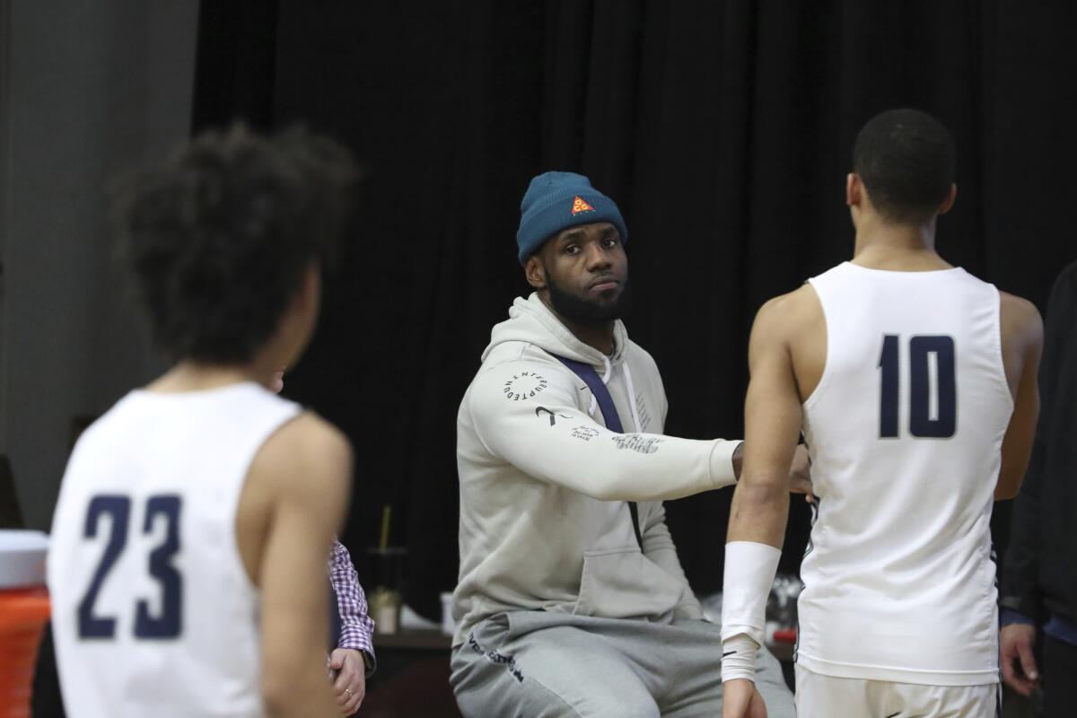 Lakers star LeBron James greets Sierra Canyon players after their loss to Fairfax (Va.) Paul VI at the HoopHall Classic on Monday in Springfield, Mass.