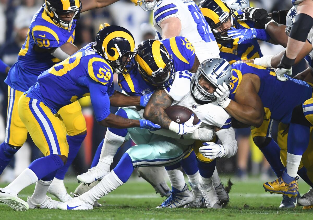 The Rams defense stops Cowboys running back Ezekiel Elliott for a short gain during the first quarter.