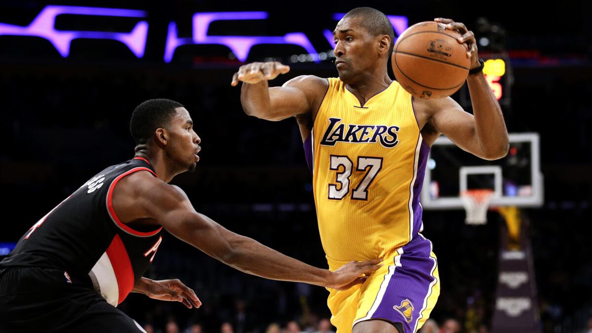 Lakers forward Metta World Peace tries to drive past Trail Blazers forward Maurice Harkless during a preseason game Oct. 19.