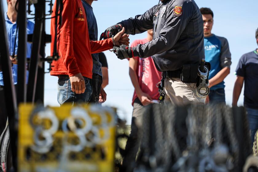 Campo, CA, Monday, June 3, 2024 - Men seeking asylum are detained by border patrol after crossing the US/Mexico border hours earlier. (Robert Gauthier/Los Angeles Times)