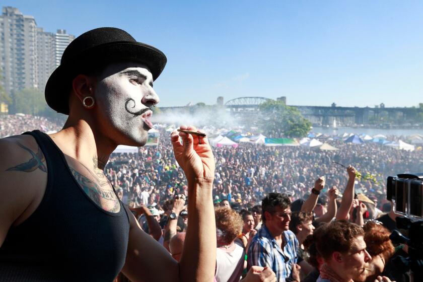 A man smokes during the 4/20 marijuana rally at Sunset Beach in Vancouver, Canada.