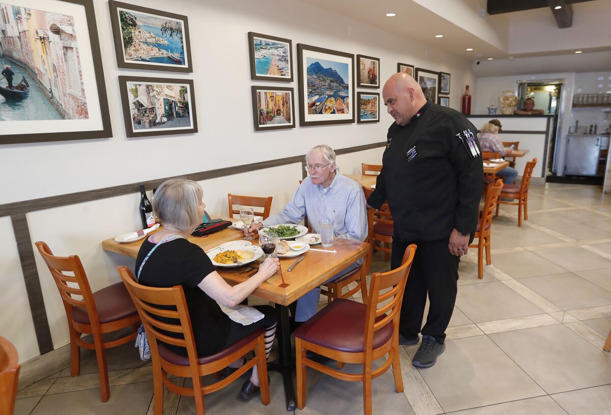 "Chef O" Oronzo Rosato chats with pleased customers at Il Farro Caffe Trattoria in Newport Beach.