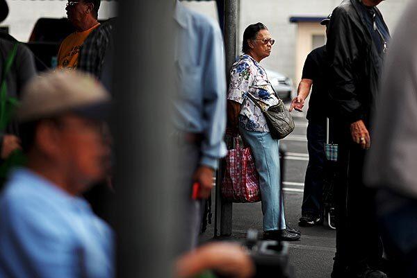 Exaltacion Divinagracia, 80, waits outside of the Islamic Center in Los Angeles. Her income is above the federal poverty level, but she relies on food pantries to make ends meet.