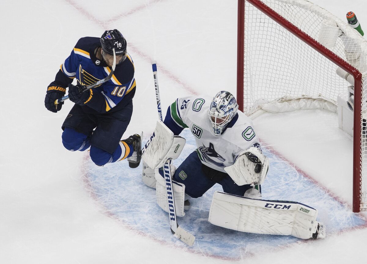 Vancouver Canucks goalie Jacob Markstrom (25) makes a save as St. Louis Blues' Brayden Schenn (10) jumps during the second period in Game 1 of an NHL hockey Stanley Cup first-round playoff series, Wednesday, Aug. 12, 2020, in Edmonton, Alberta. (Jason Franson/The Canadian Press via AP)