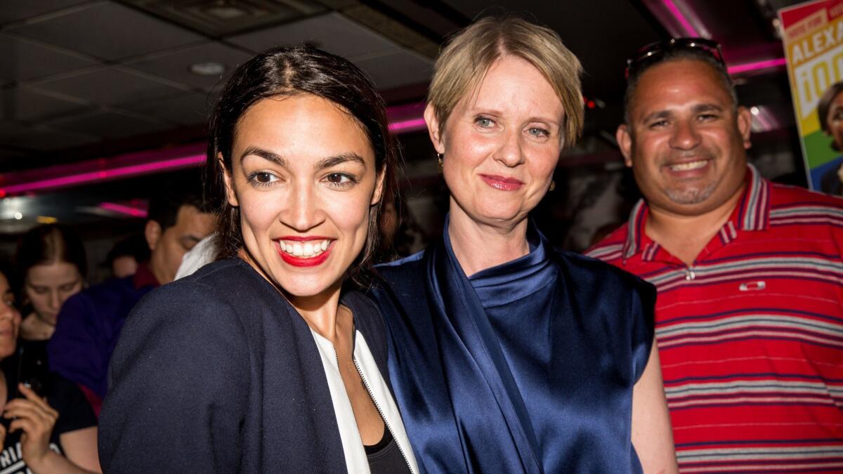 Alexandria Ocasio-Cortez, left, is joined by New York gubenatorial candidate Cynthia Nixon at a victory party in the Bronx after upsetting incumbent Democratic Representative Joseph Crowly on June 26.