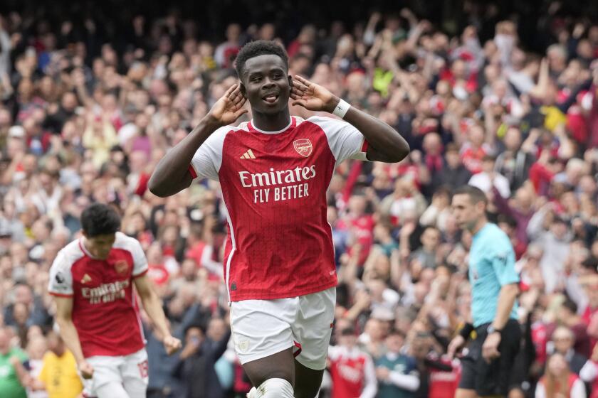 Arsenal's Bukayo Saka celebrates after scoring his side's opening goal during the English Premier League soccer match between Arsenal and Bournemouth at Emirates Stadium in London, England, Saturday, May 4, 2024. (AP Photo/Frank Augstein)