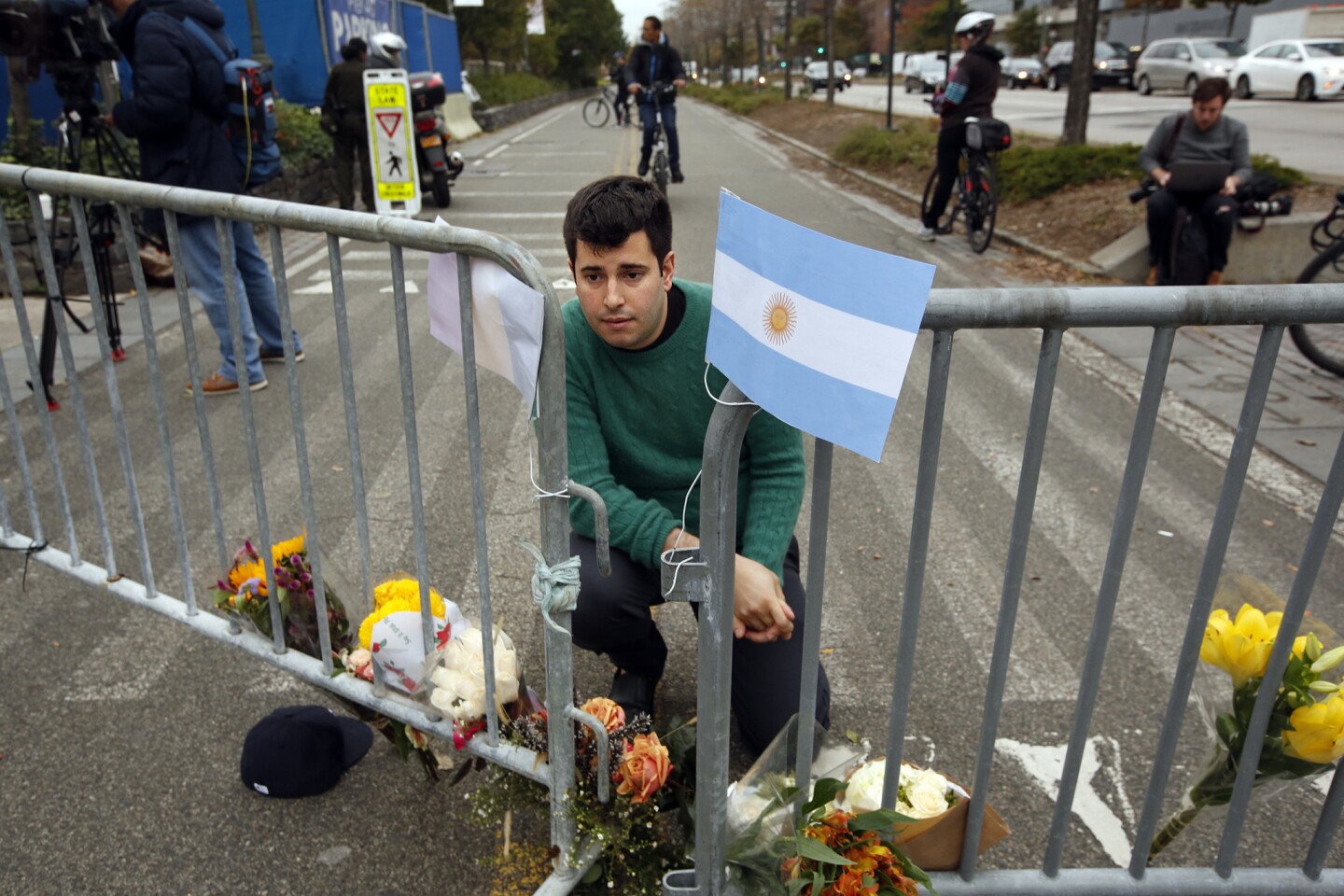 George Embiricos, 27, leaves flowers on the bike path along West Street in Manhattan. "I walk the path every day. It's been a source of peace for me. It's hard to see the city where I grew up like this," he said.