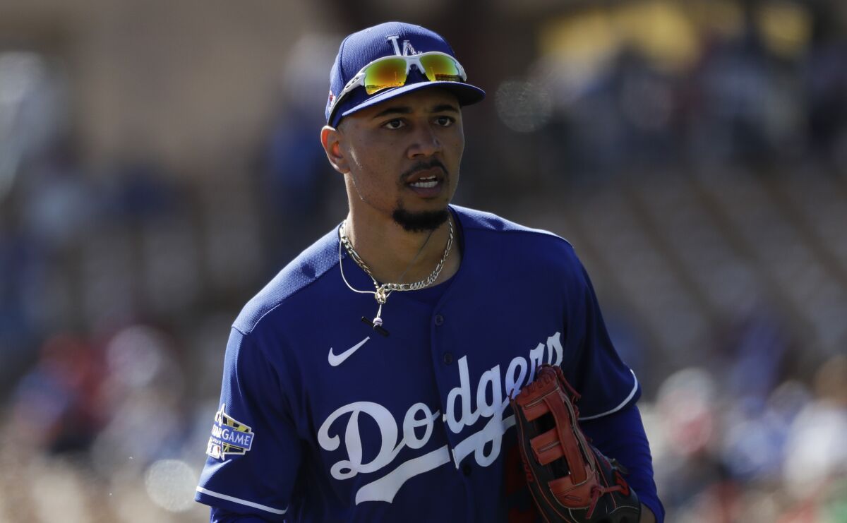 Dodgers right fielder Mookie Betts runs on the field during a spring training game.
