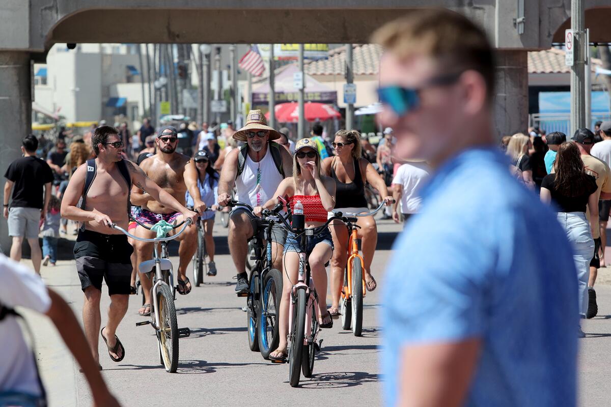 Crowds enjoy the sun on Labor Day in Huntington Beach.