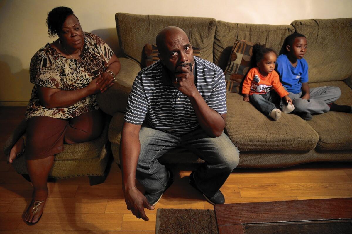 Rhasson Hamilton, who was killed in October, left behind his large family, including his mother, Pamela, left; father, Rodney; nephews Ramon and Caleb at right, and three young children.