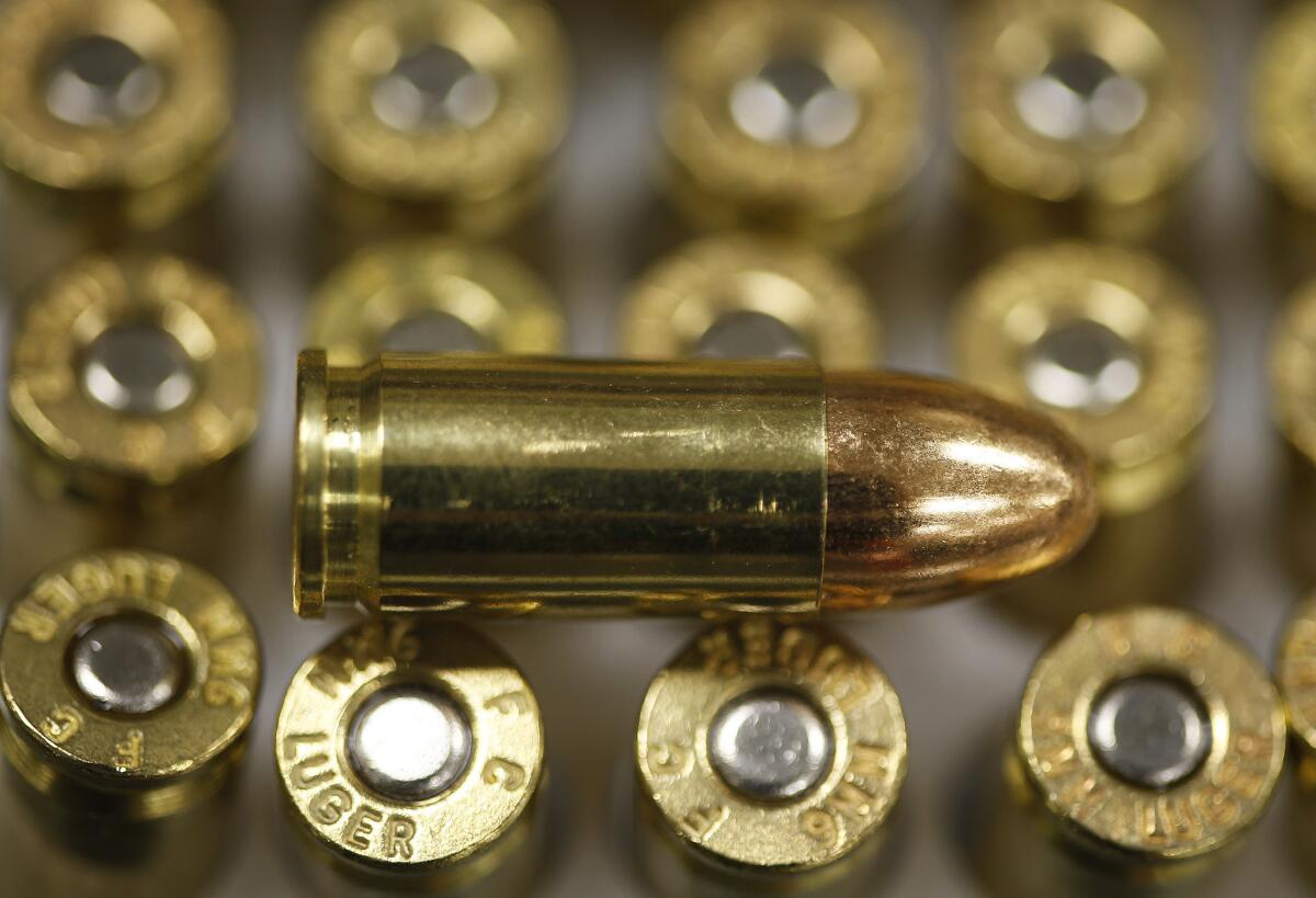 A 9-millimeter bullet rests on top of others in a box. A California lawmaker wants to put a five-cent tax on each bullet.