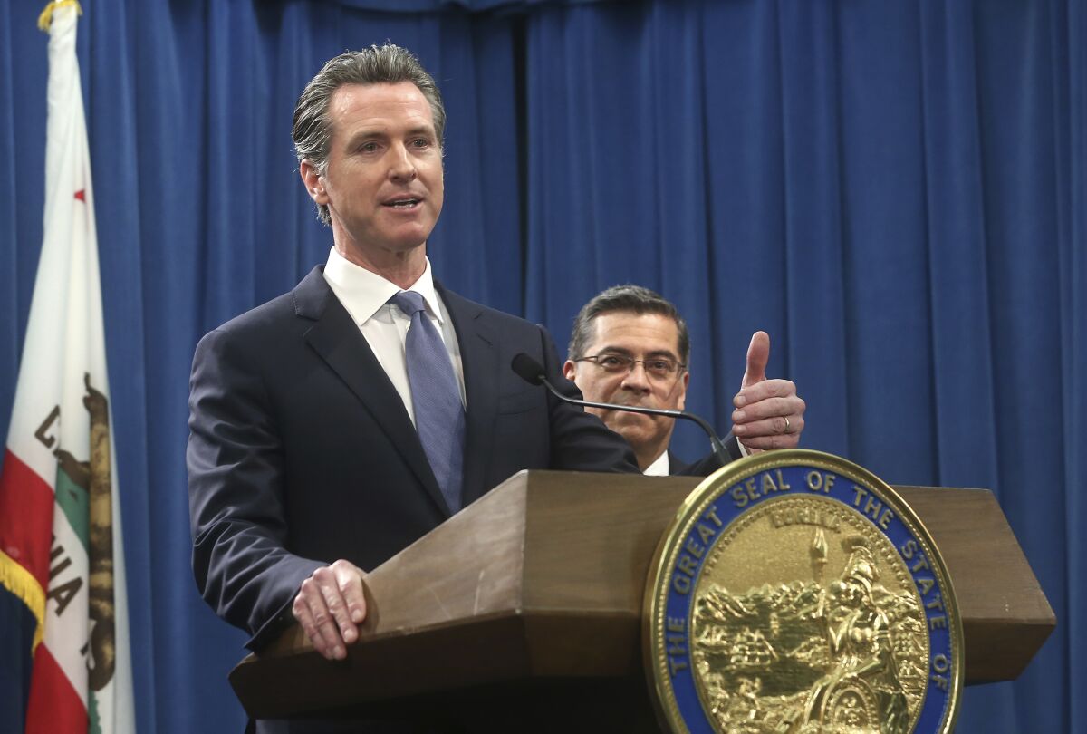 FILE - In this Feb. 15, 2019, file photo, California Gov. Gavin Newsom, left, flanked by Attorney General Xavier Becerra, right, answers a question during a news conference in Sacramento, Calif. With President-elect Joe Biden tapping California's attorney general for his cabinet, Newsom now has the chance to pick California's next top prosecutor and its next U.S. Senator, power that could shape the state's politics for decades to come. (AP Photo/Rich Pedroncelli, File)