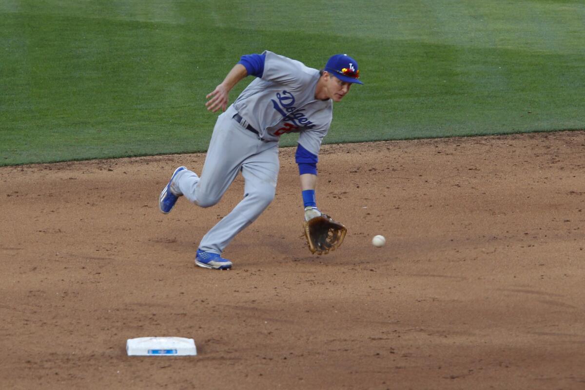 Dodgers second baseman Chase Utley fields an infield ground ball to throw out Padres Jon Jay in the 6th inning.