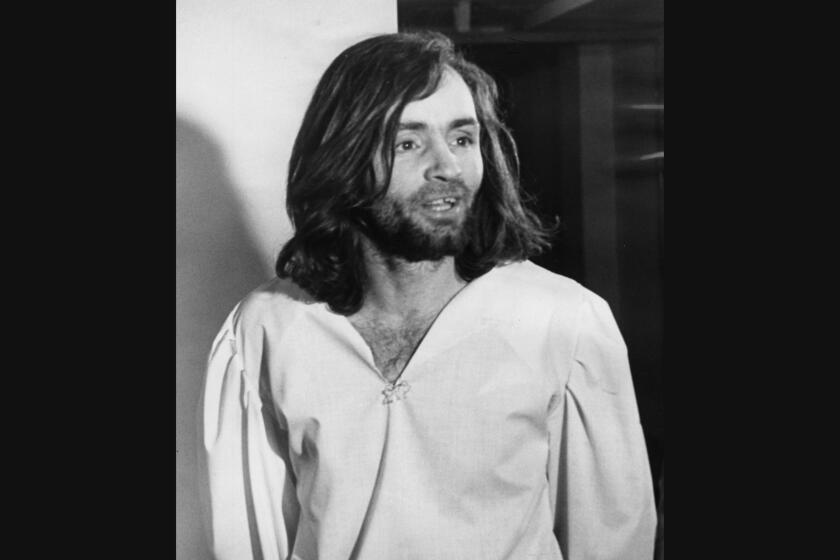 Charles Manson is led back to his cell after court appearance in 1970.