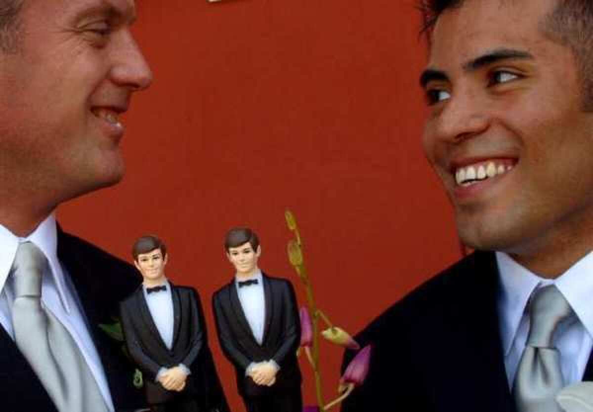 Protests are planned after a Denver-area bakery turned away a gay couple's wedding cake order. Above, a different couple -- West Hollywood Councilman Jeffrey Prang, left, and his partner, Raymundo Vizcarra -- pose with their cake's two groom figurines outside West Hollywood City Hall in 2004.