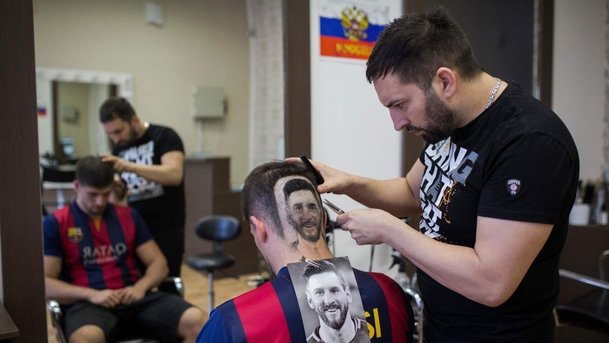 Hairdresser Mario Hvala creates a hair tattoo showing Argentine player Lionel Messi in Novi Sad, Serbia.