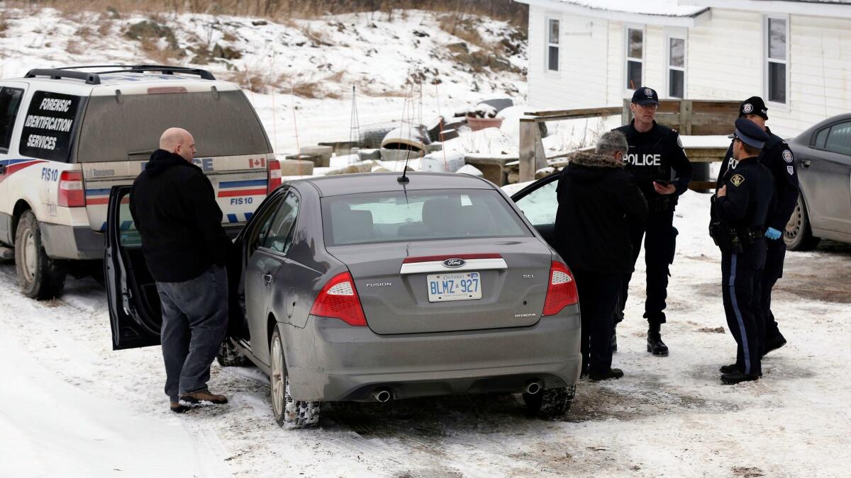 Forensic officers outside a home connected to alleged serial killer Bruce McArthur, in Madoc, Canada.
