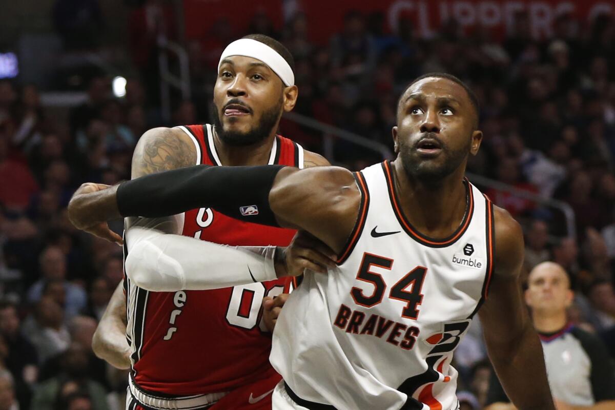 Clippers power forward Patrick Patterson boxes out Trail Blazers power forward Carmelo Anthony during a game Dec. 3 at Staples Center.