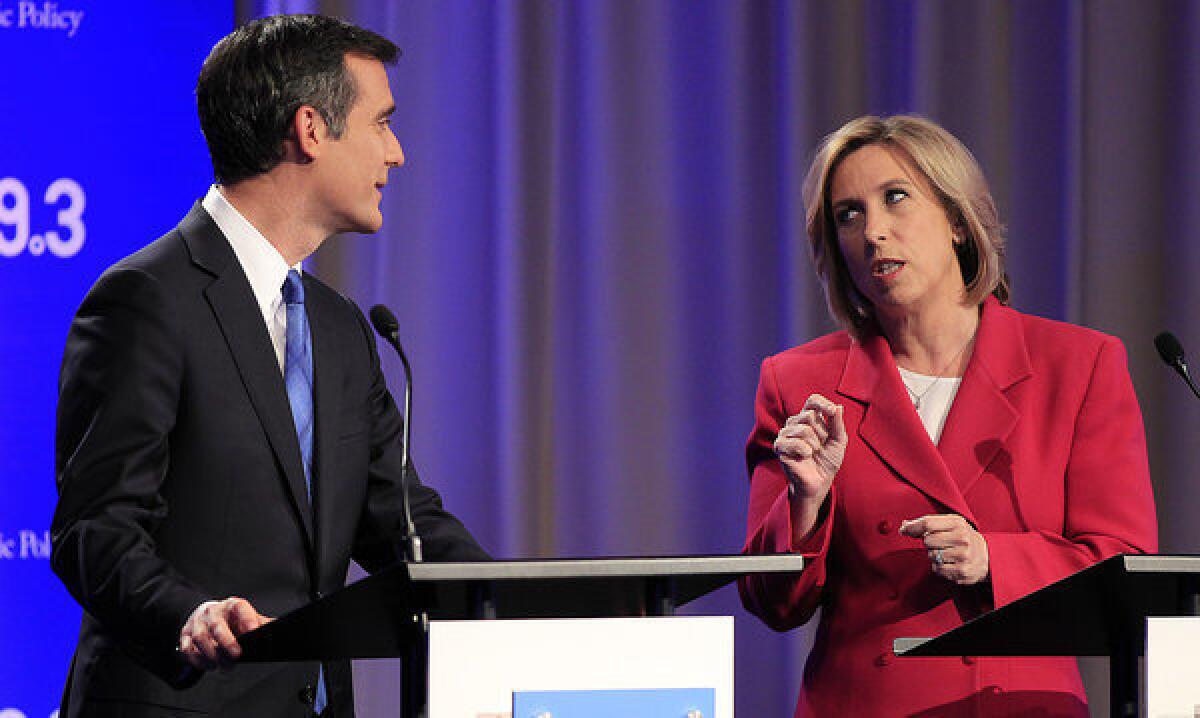 Los Angeles mayoral candidates Wendy Greuel, right, and Eric Garcetti chat before they squared off in a debate at the Louis B. Mayer Auditorium at USC's Health Sciences Campus.