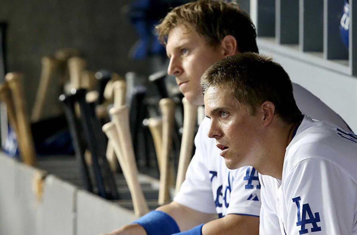Starting pitcher Zack Greinke, right, with catcher A.J. Ellis during a game last season, canceled a bullpen session for Saturday, making it unlikely he'll be able to make a start in Australia when the Dodgers open the season against Arizona.